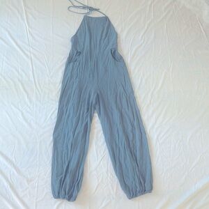 Blue jumpsuit with open back and pockets